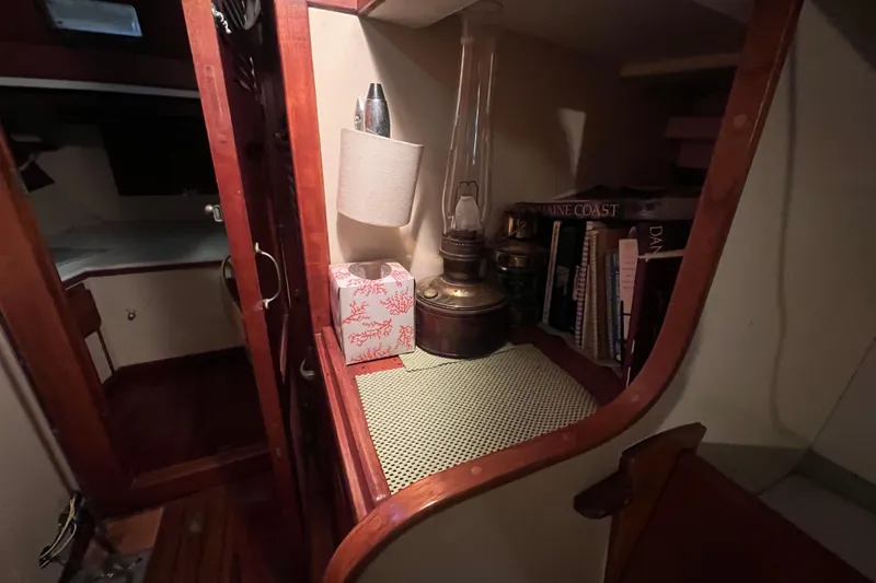 Slide: The Image of Interior of 1962 Ted Hood Little Harbor 40 Yawl with books and vintage lamp. - 22
