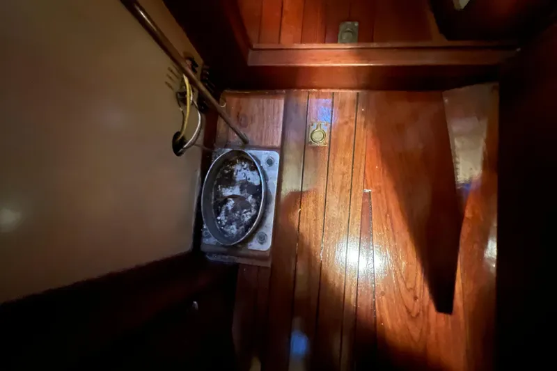 Slide: The Image of Interior of 1962 Ted Hood Little Harbor 40 Yawl, featuring wooden flooring and nautical details. - 23