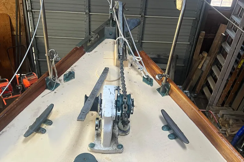 Slide: The Image of 1962 Ted Hood Little Harbor 40 Yawl deck with anchor chain and cleats in a workshop. - 39