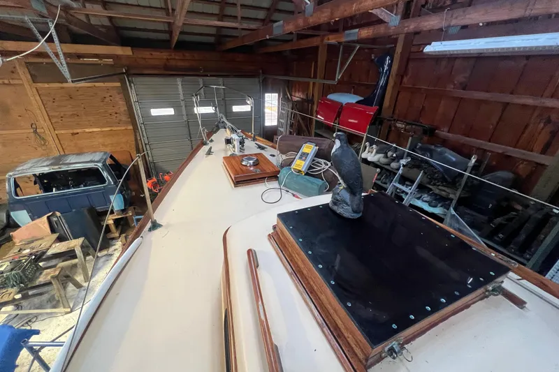 Slide: The Image of 1962 Ted Hood Little Harbor 40 Yawl in a wooden garage, showcasing deck details. - 45