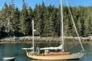 Slide: The Image of 1962 Ted Hood Little Harbor 40 Yawl sailing in serene forested waters. - 49