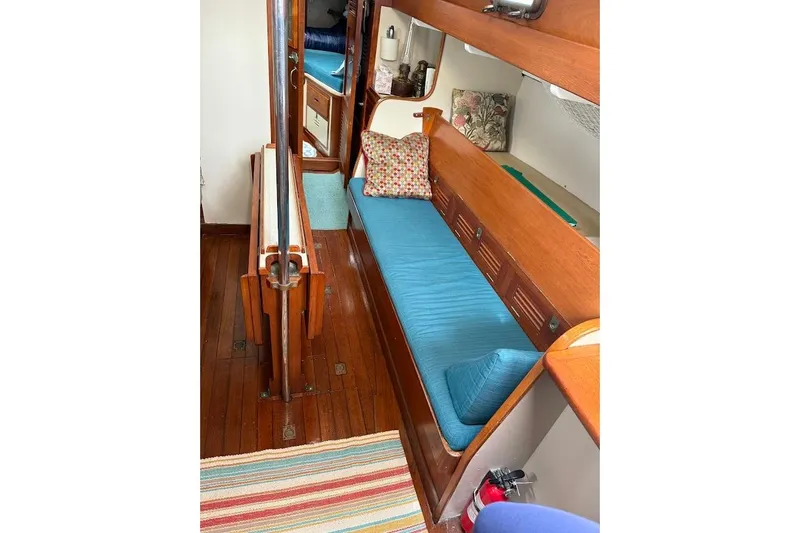 Slide: The Image of Interior of 1962 Ted Hood Little Harbor 40 Yawl with blue cushions and wooden finish. - 8