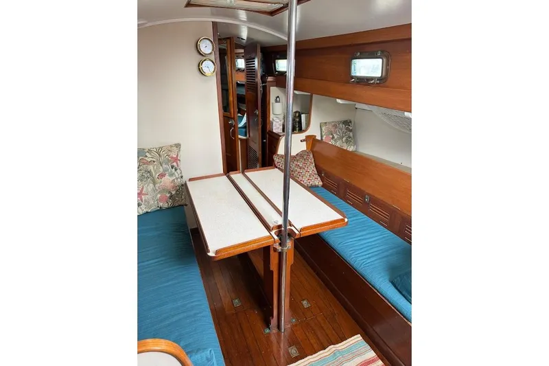 Slide: The Image of Interior of 1962 Ted Hood Little Harbor 40 Yawl, featuring wooden furnishings and cozy seating. - 9