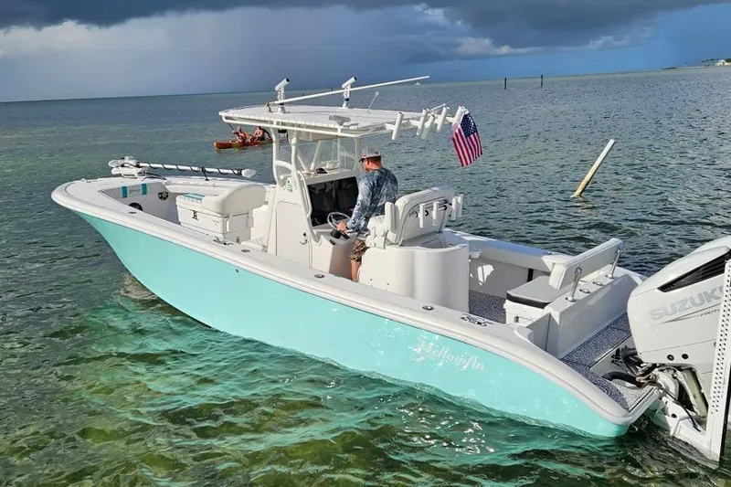 The Image of 2002 Yellowfin 31 Center Console boat on clear water, American flag, Suzuki engine. - 0