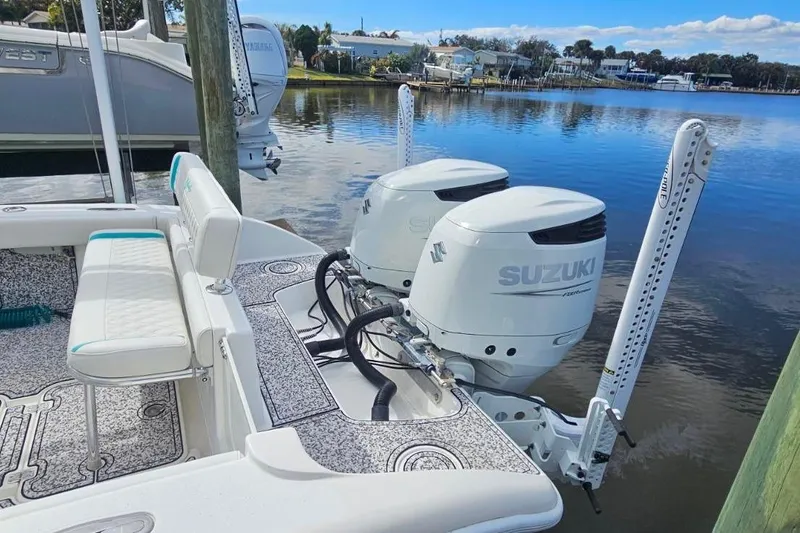 Slide: The Image of 2002 Yellowfin 31 Center Console boat with twin Suzuki outboard motors docked by the water. - 13