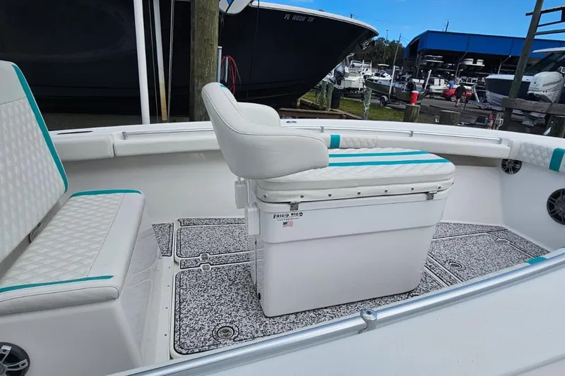 Slide: The Image of 2002 Yellowfin 31 Center Console boat interior with cushioned seating and non-slip flooring. - 15