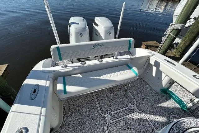 Slide: The Image of 2002 Yellowfin 31 Center Console boat with twin engines, docked by the water. - 19