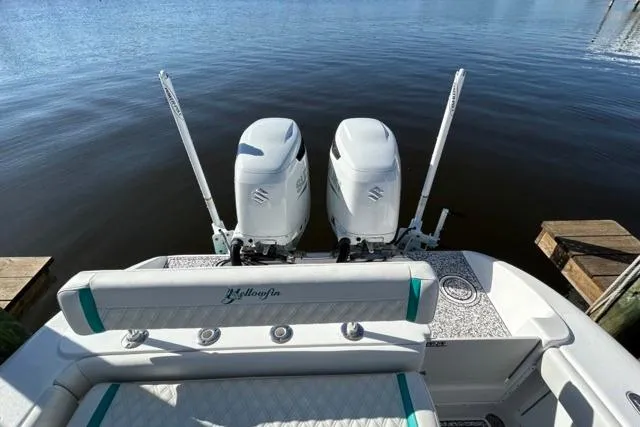 Slide: The Image of 2002 Yellowfin 31 Center Console boat with twin Suzuki outboard motors on calm water. - 20