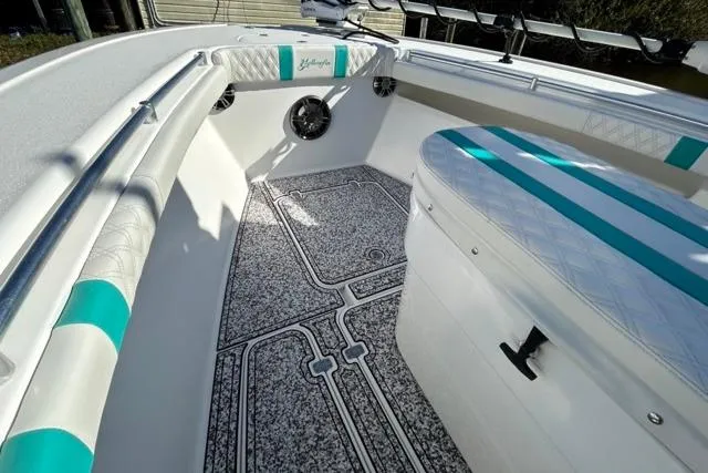 Slide: The Image of 2002 Yellowfin 31 Center Console boat interior with teal accents and textured flooring. - 22