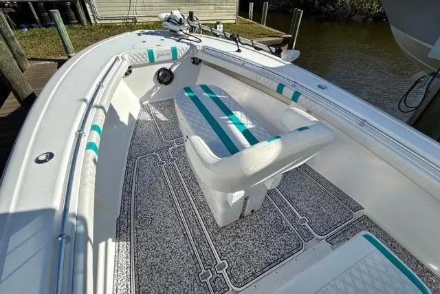 Slide: The Image of 2002 Yellowfin 31 Center Console boat with striped seating and textured flooring. - 24