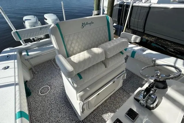Slide: The Image of 2002 Yellowfin 31 Center Console boat interior with cushioned seating and steering wheel. - 26
