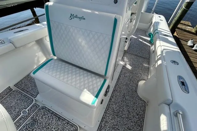 Slide: The Image of 2002 Yellowfin 31 Center Console boat interior with white and teal seating. - 29