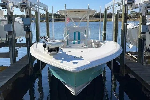 Slide: The Image of 2002 Yellowfin 31 Center Console boat docked on a lift, ready for adventure. - 30