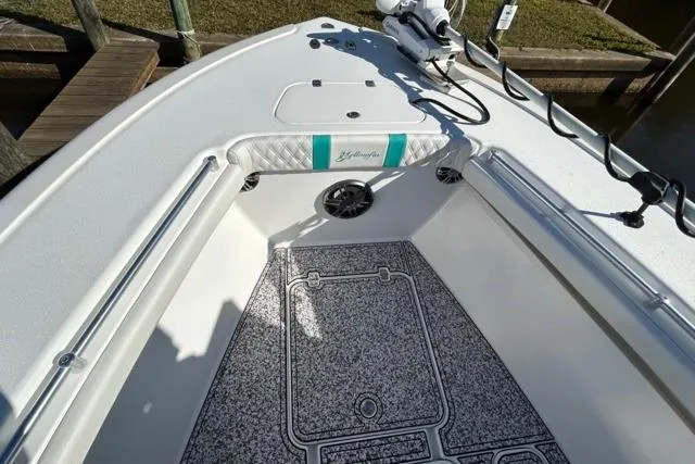 Slide: The Image of 2002 Yellowfin 31 Center Console boat interior with non-slip flooring and fishing rod holders. - 31