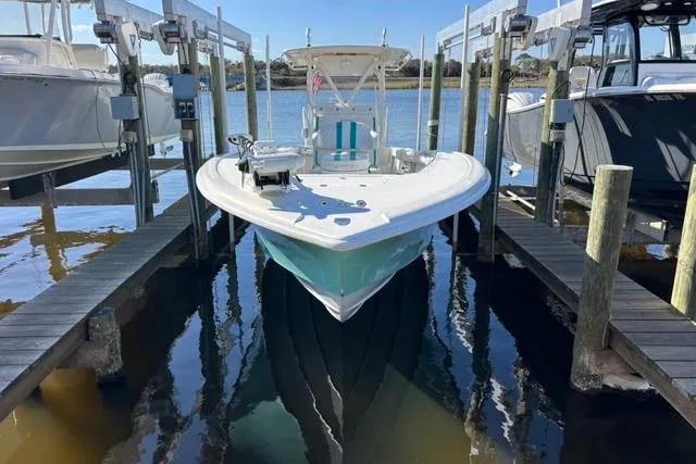 Slide: The Image of 2002 Yellowfin 31 Center Console boat docked in marina. - 32