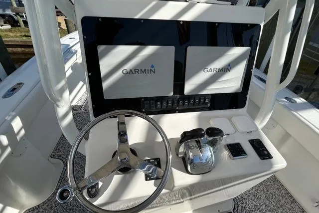 Slide: The Image of Center console of a 2002 Yellowfin 31 with Garmin displays and steering wheel. - 33