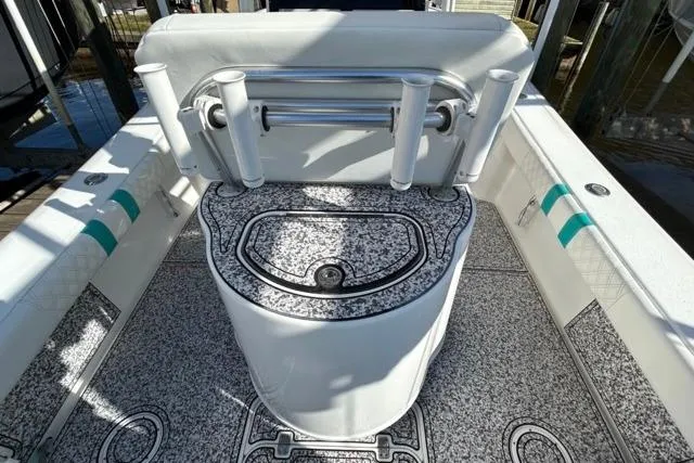 Slide: The Image of 2002 Yellowfin 31 Center Console boat interior with rod holders and patterned flooring. - 34