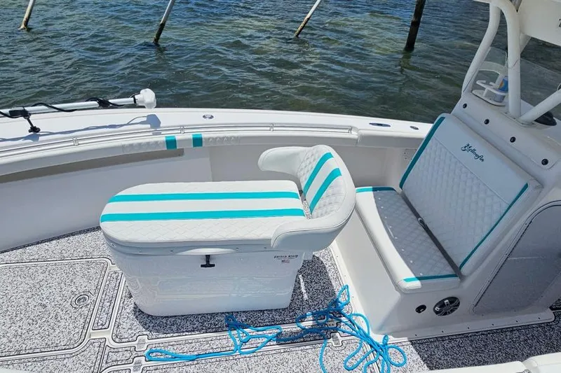 Slide: The Image of 2002 Yellowfin 31 Center Console boat interior with striped seating and blue accents. - 4