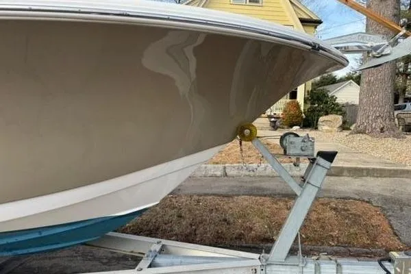 Slide: The Image of 2015 Tidewater 232 LXF boat on trailer, parked in residential area. - 10