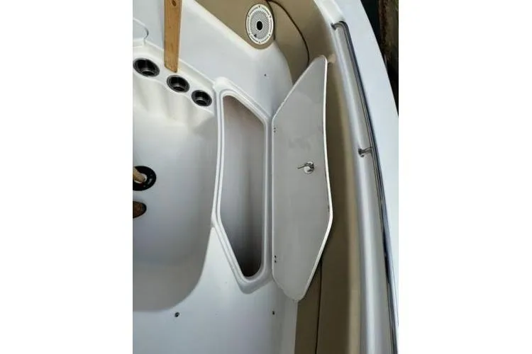 Slide: The Image of 2015 Tidewater 232 LXF boat interior storage compartment with open hatch. - 13