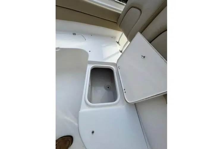 Slide: The Image of 2015 Tidewater 232 LXF boat interior with open storage compartment. - 15