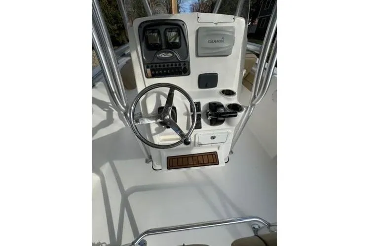 Slide: The Image of 2015 Tidewater 232 LXF boat console with steering wheel and Garmin navigation system. - 16