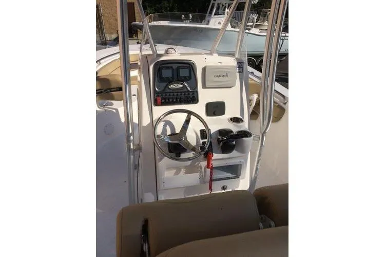 Slide: The Image of 2015 Tidewater 232 LXF boat console with steering wheel and navigation equipment. - 18