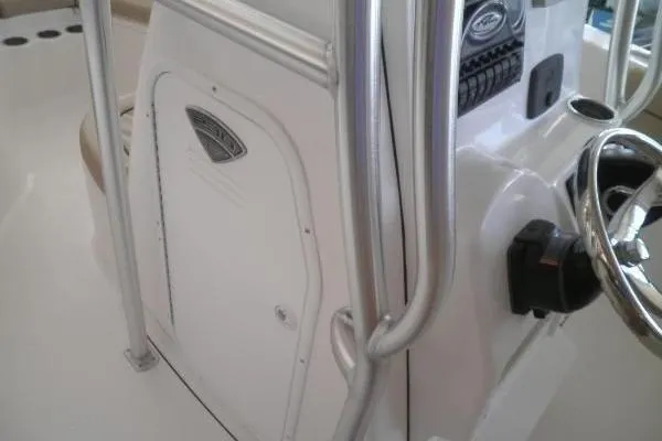 Slide: The Image of 2015 Tidewater 232 LXF boat console with steering wheel and control panel. - 19