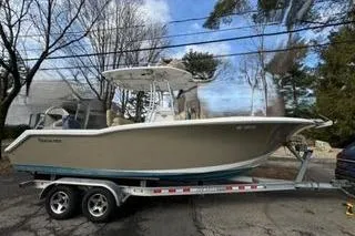 Slide: The Image of 2015 Tidewater 232 LXF boat on trailer, parked outdoors. - 2