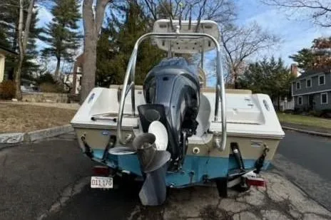 Slide: The Image of 2015 Tidewater 232 LXF boat with outboard motor, parked on a residential street. - 22