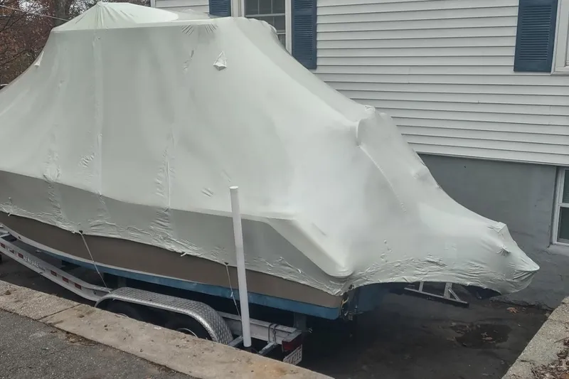 Slide: The Image of 2015 Tidewater 232 LXF boat covered and stored on a trailer. - 3