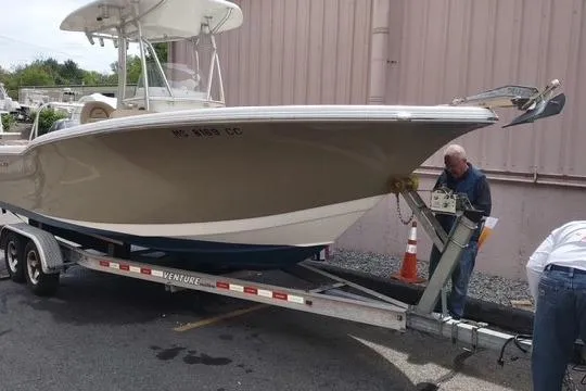 Slide: The Image of 2015 Tidewater 232 LXF boat on trailer, parked outdoors. - 4
