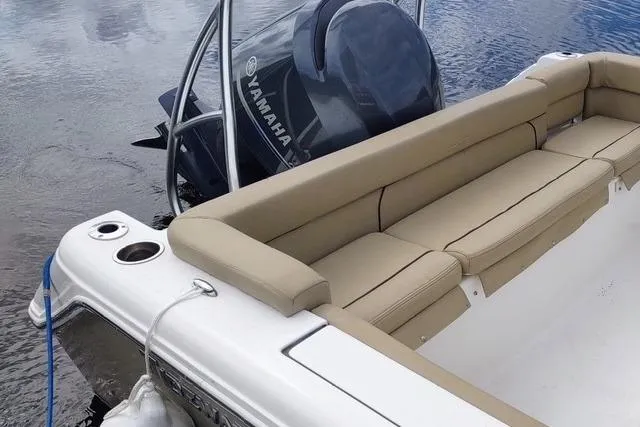 Slide: The Image of 2015 Tidewater 232 LXF boat with Yamaha engine and beige seating on calm water. - 7