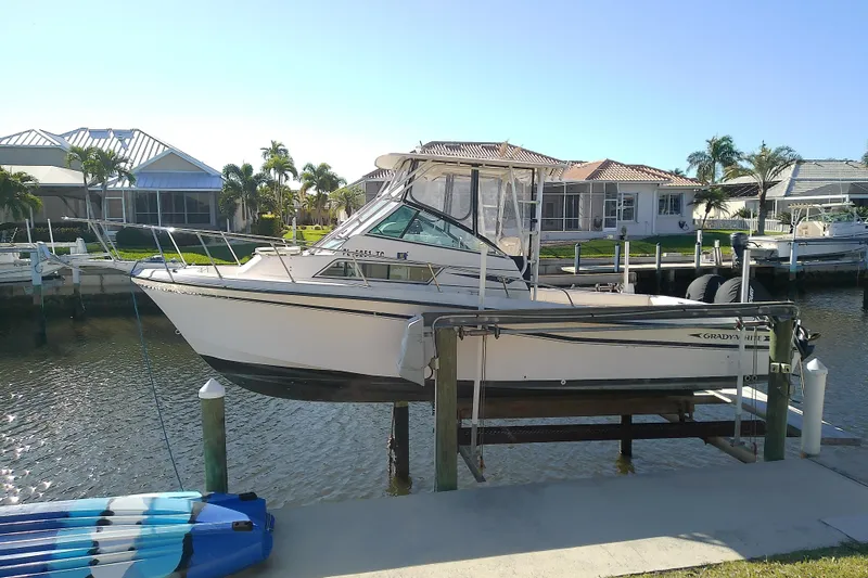 The Image of 1995 Grady-White Sailfish 272 boat docked in a sunny waterfront setting. - 1