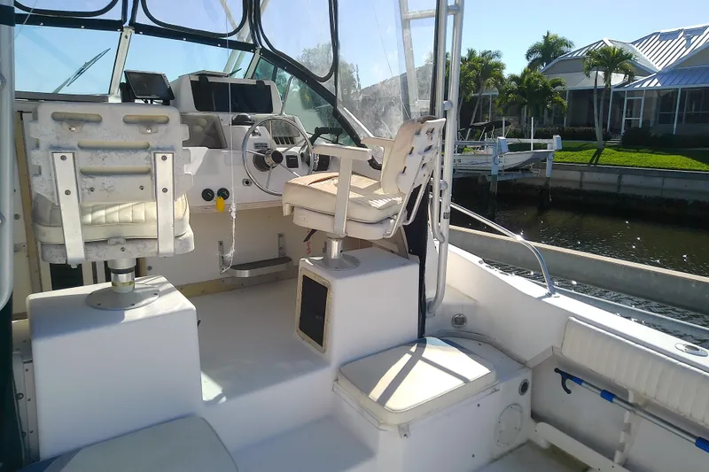 Slide: The Image of 1995 Grady-White Sailfish 272 boat interior with steering wheel and seating. - 12