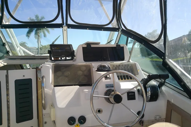 Slide: The Image of 1995 Grady-White Sailfish 272 boat helm with steering wheel and navigation equipment. - 18