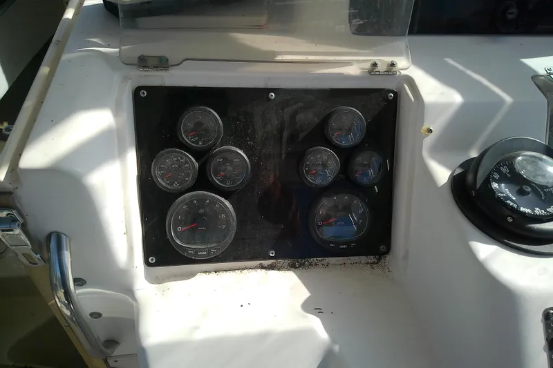 Slide: The Image of Dashboard of a 1995 Grady-White Sailfish 272 boat with gauges and compass. - 20