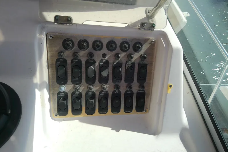 Slide: The Image of Control panel of a 1995 Grady-White Sailfish 272 boat with various switches. - 21