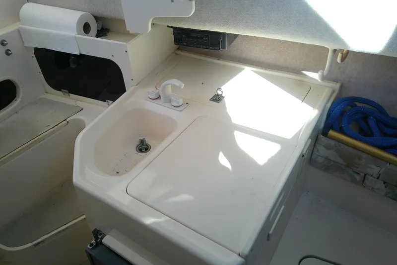 Slide: The Image of Interior of a 1995 Grady-White Sailfish 272 boat with sink and storage area. - 25