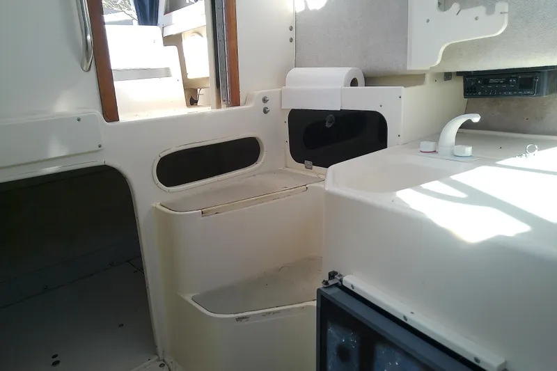 Slide: The Image of Interior of 1995 Grady-White Sailfish 272 boat, featuring compact kitchen area. - 29