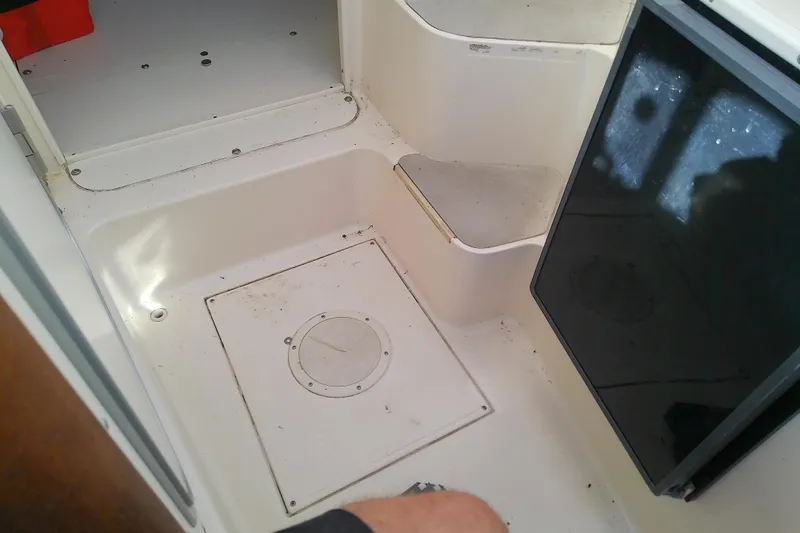 Slide: The Image of 1995 Grady-White Sailfish 272 interior, showing cabin floor and storage compartment. - 30