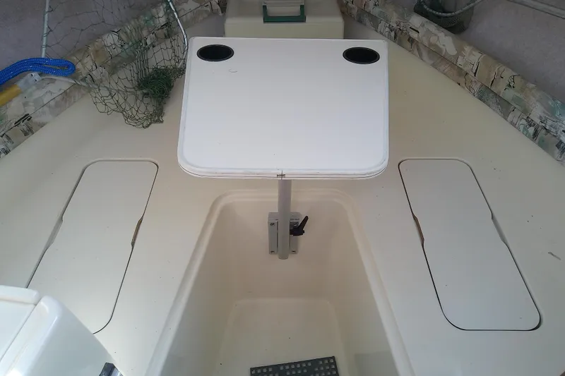 Slide: The Image of 1995 Grady-White Sailfish 272 boat interior with table and storage compartments. - 34