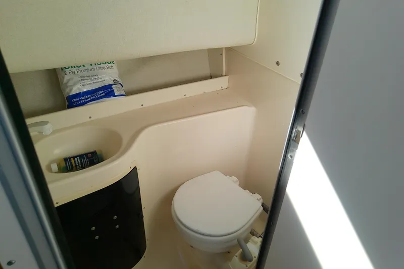 Slide: The Image of 1995 Grady-White Sailfish 272 boat bathroom with toilet and storage area. - 35