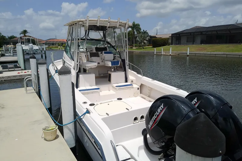 Slide: The Image of 1995 Grady-White Sailfish 272 boat docked, featuring dual Mercury outboard engines. - 39