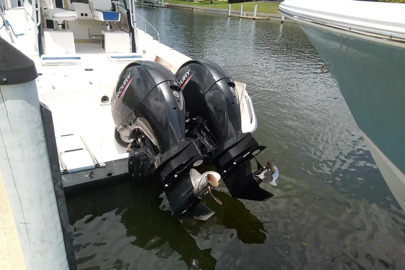 Slide: The Image of 1995 Grady-White Sailfish 272 with twin Mercury outboard engines docked in a marina. - 41
