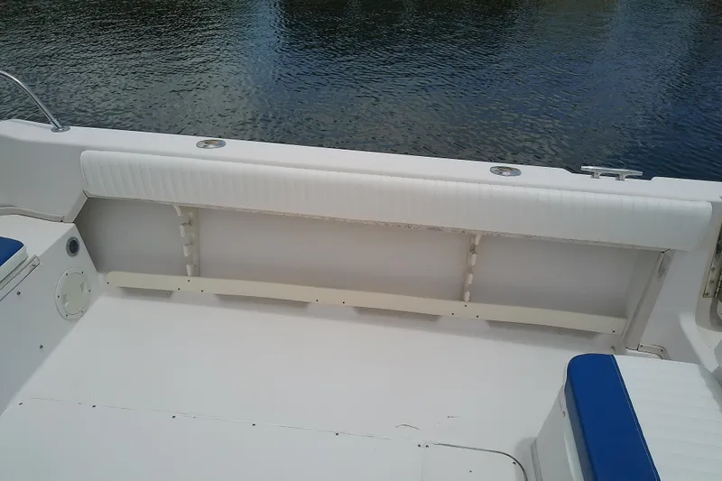 Slide: The Image of 1995 Grady-White Sailfish 272 boat interior with white seating and blue accents. - 46