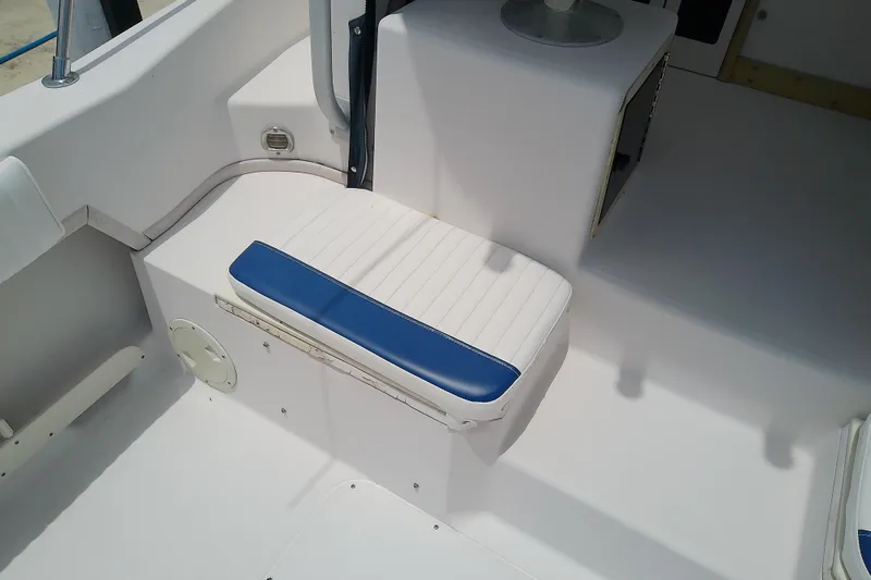 Slide: The Image of 1995 Grady-White Sailfish 272 boat interior with white and blue cushioned seating. - 48