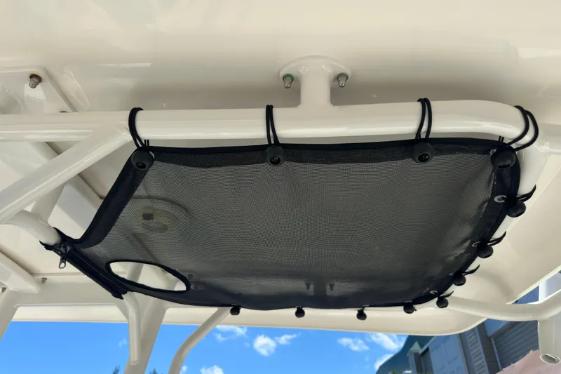 Slide: The Image of 2022 Boston Whaler 210 Montauk boat with overhead storage netting. - 14