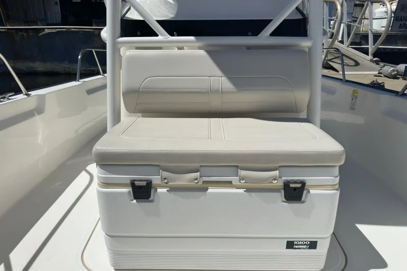 Slide: The Image of 2022 Boston Whaler 210 Montauk boat seat with integrated cooler on deck. - 16