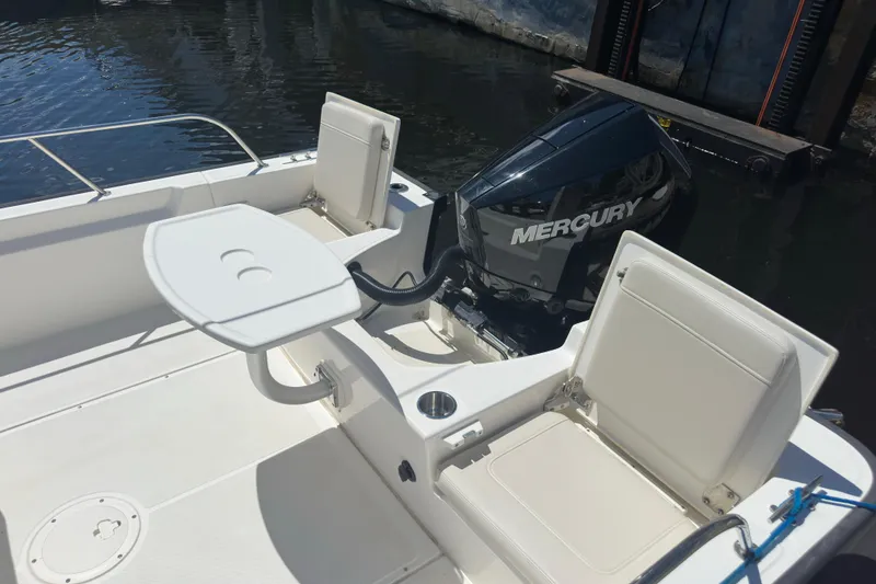 Slide: The Image of 2022 Boston Whaler 210 Montauk boat interior with Mercury engine and seating. - 5